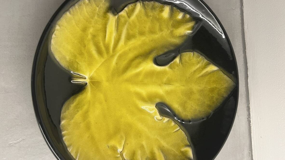 Wall plate by Pol Chambost with leaf pattern.