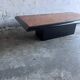 Vintage coffee table in wood burl on a black lacquered base.
