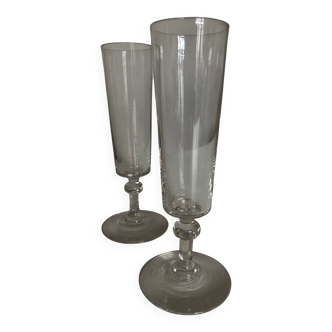 Pair of crystal champagne flutes with a button foot, 1960.