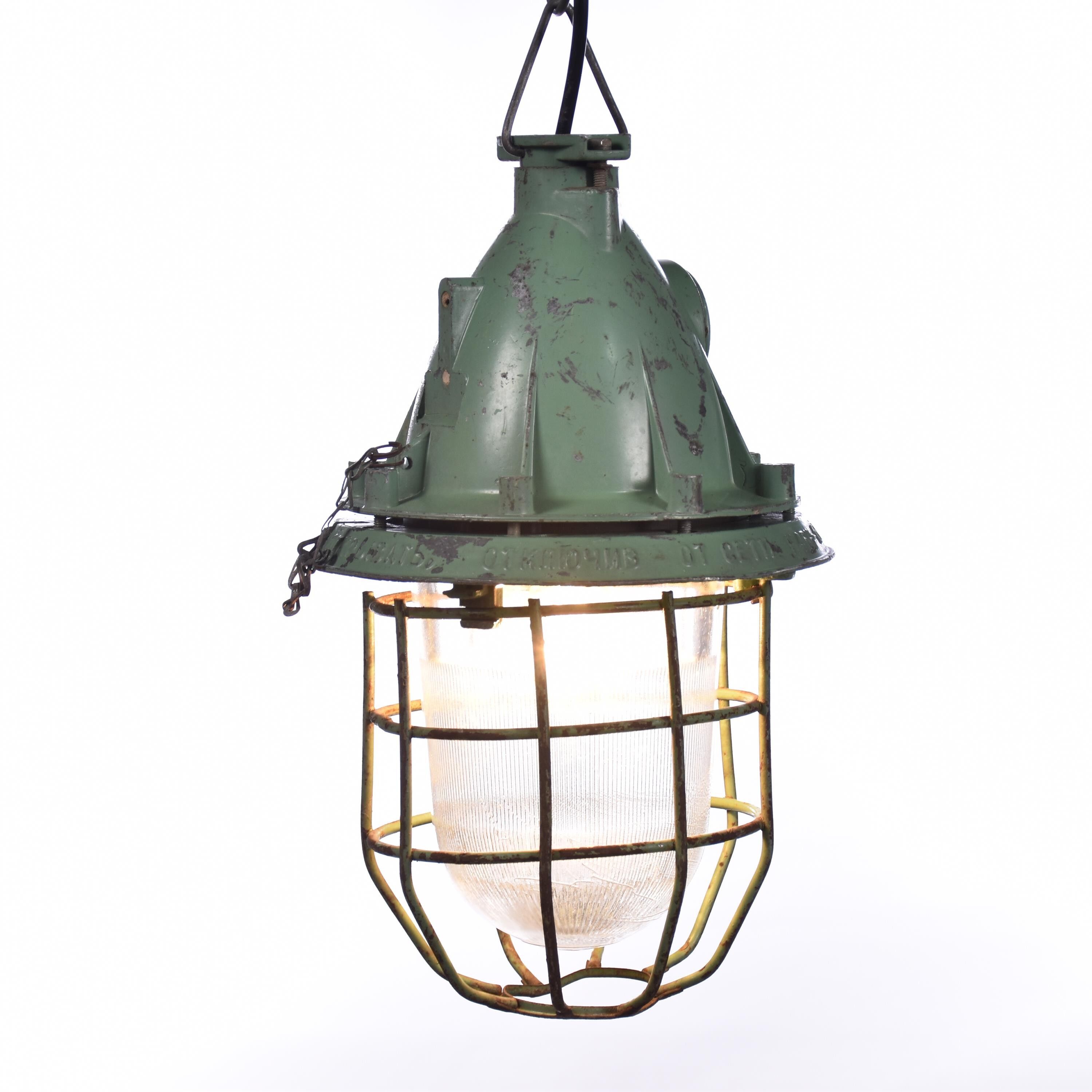 Industrial caged green lamp