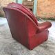 Burgundy leather club chair from the 1950s, with tufted back and studs.