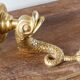 Wall-mounted candle holder, dolphin, bronze and gilded brass