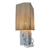 Table lamp in ceramic with decorative chain and cord shade.