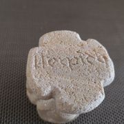 Candlestick in carved stone, signed