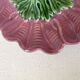 Antique slip candlestick depicting a flower