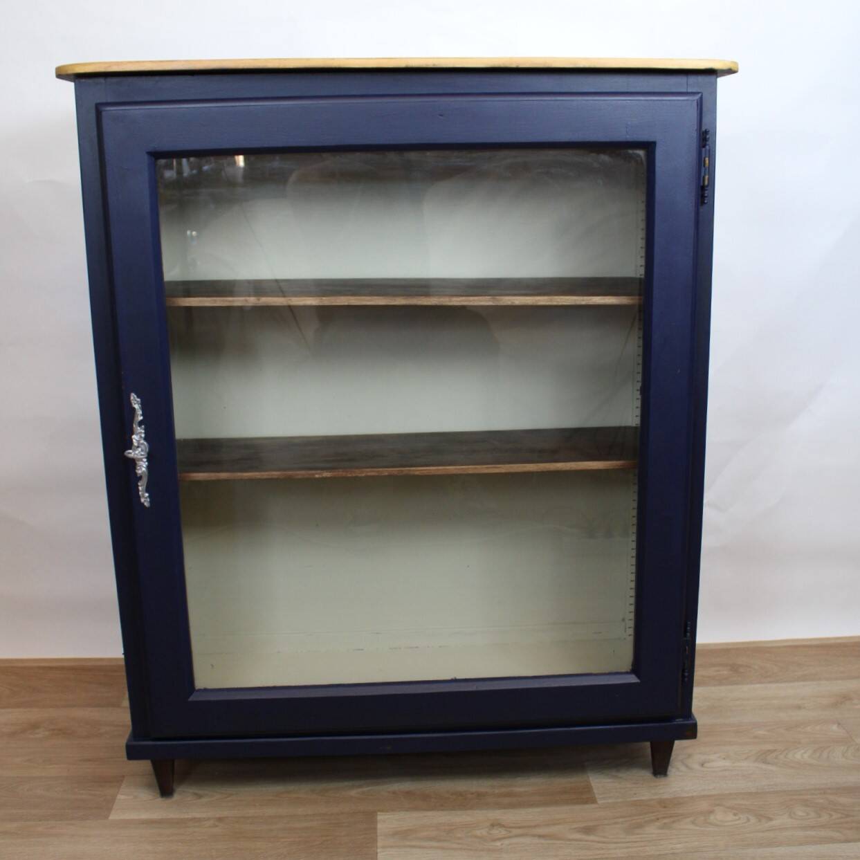 Vintage low glass-fronted library in midnight blue, 1950s.