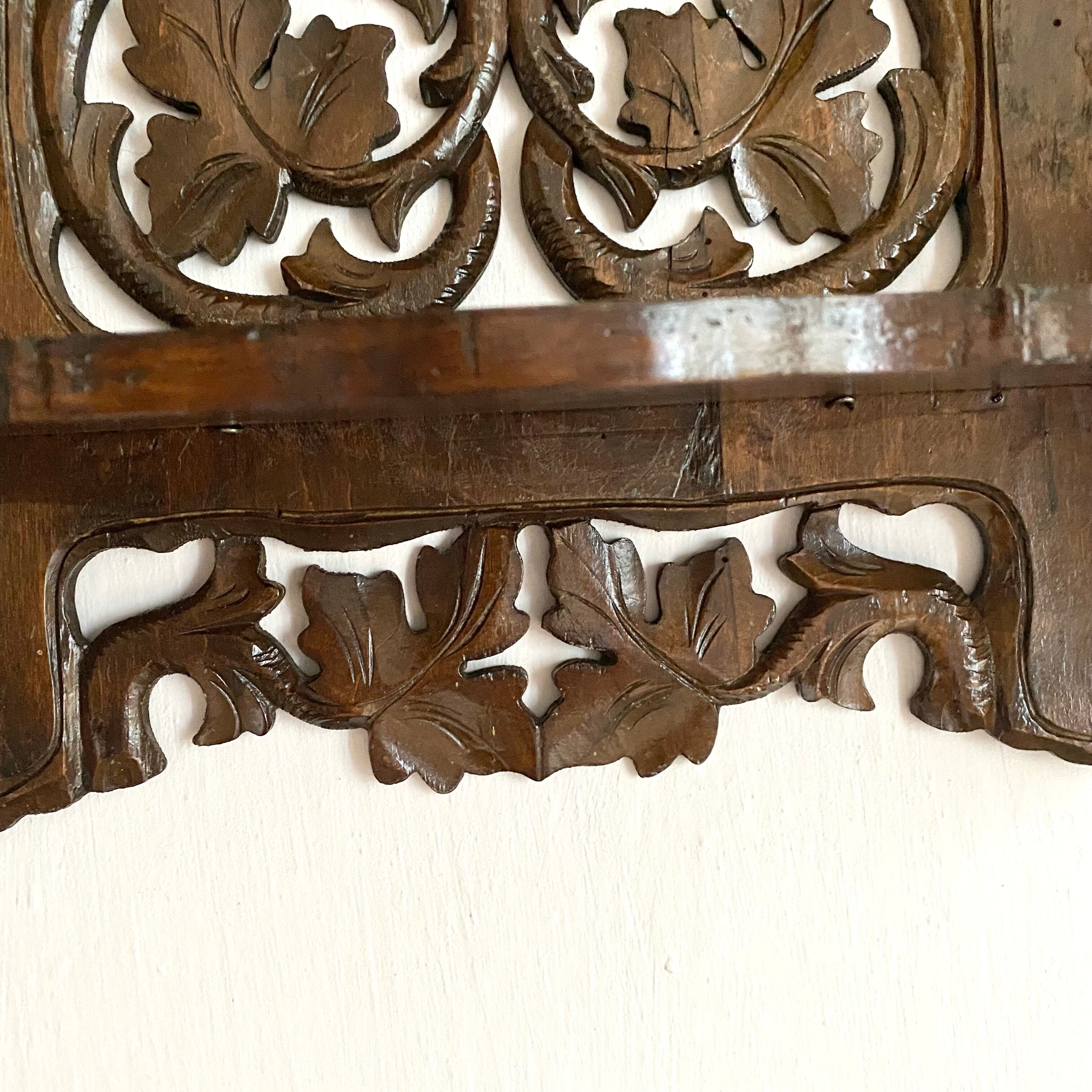 Carved wooden wall shelf