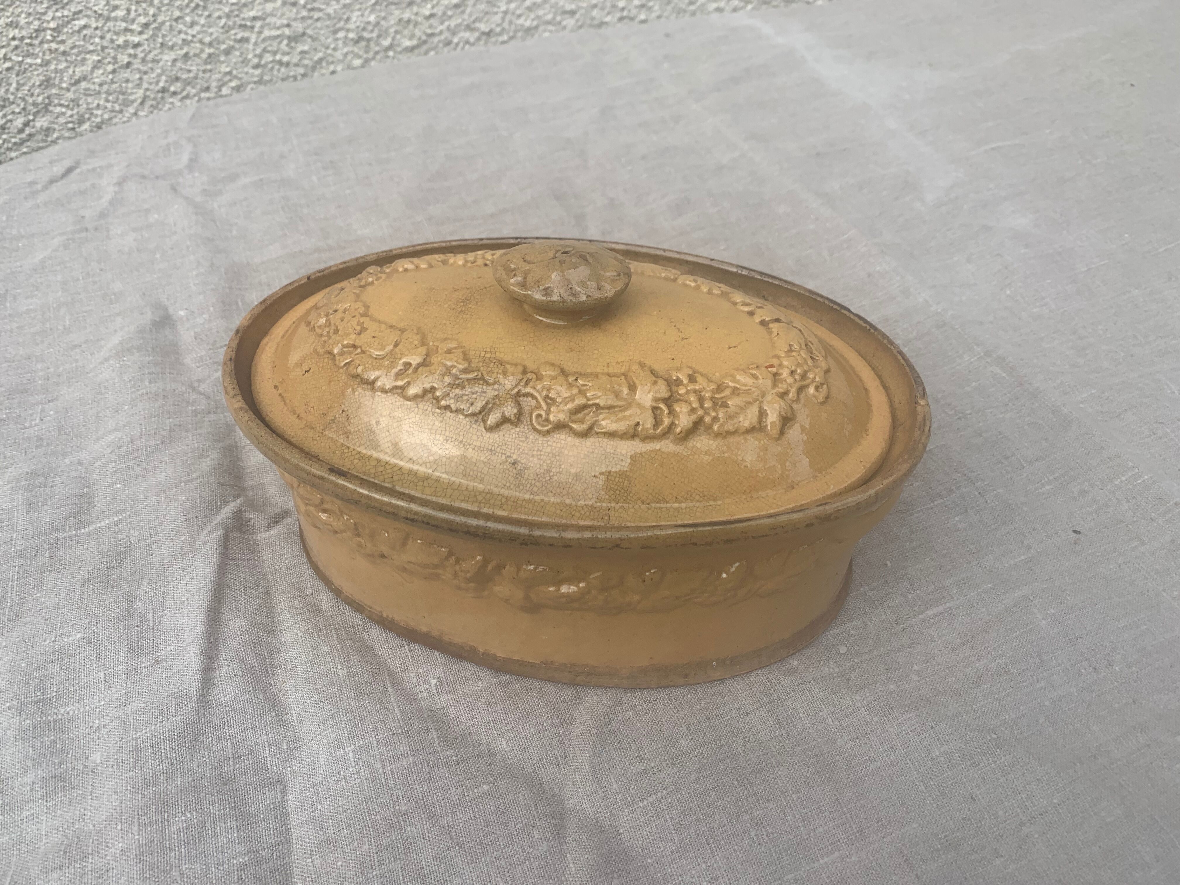 Old terrine in glazed stoneware and floral decoration mustard yellow slip