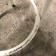 Vintage bar stool in white lace-up, round wooden seat rests circular feet