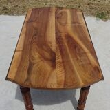 Round drop-leaf table made entirely of solid walnut