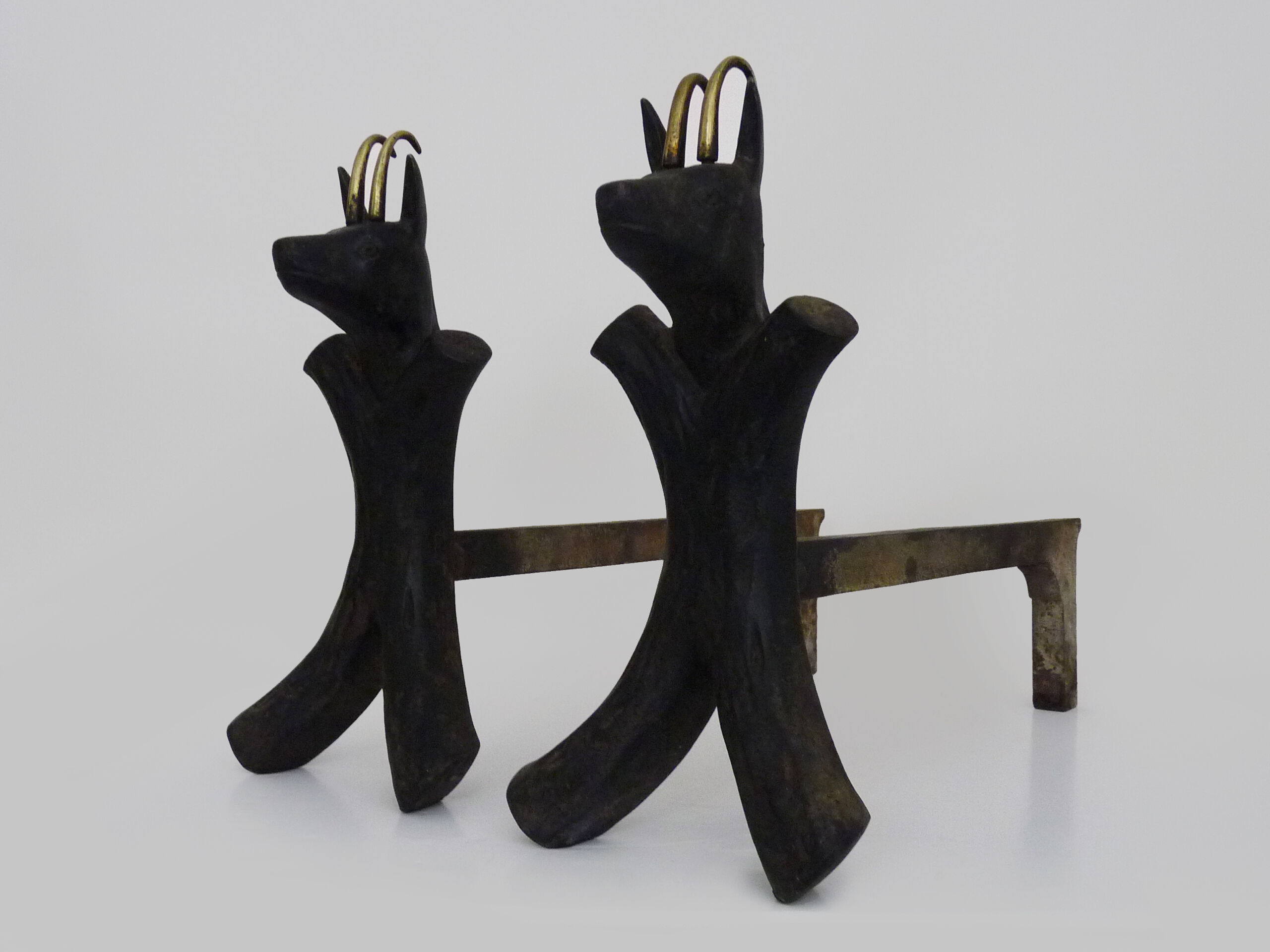 Pair of zoomorphic cast iron chimney pegs representing Isards. 50s