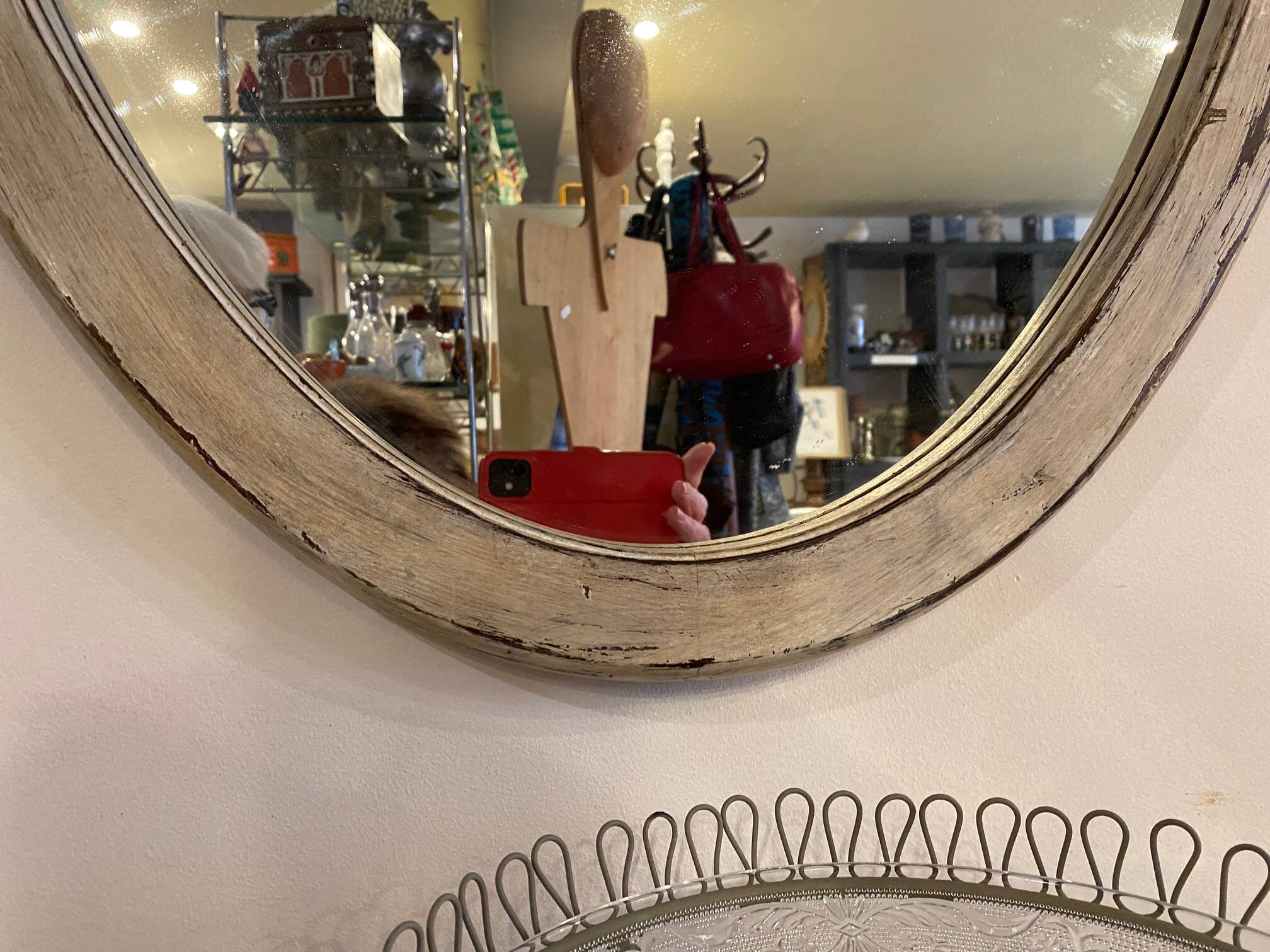 Large old oval mirror with beige patina wooden frame early 20th century