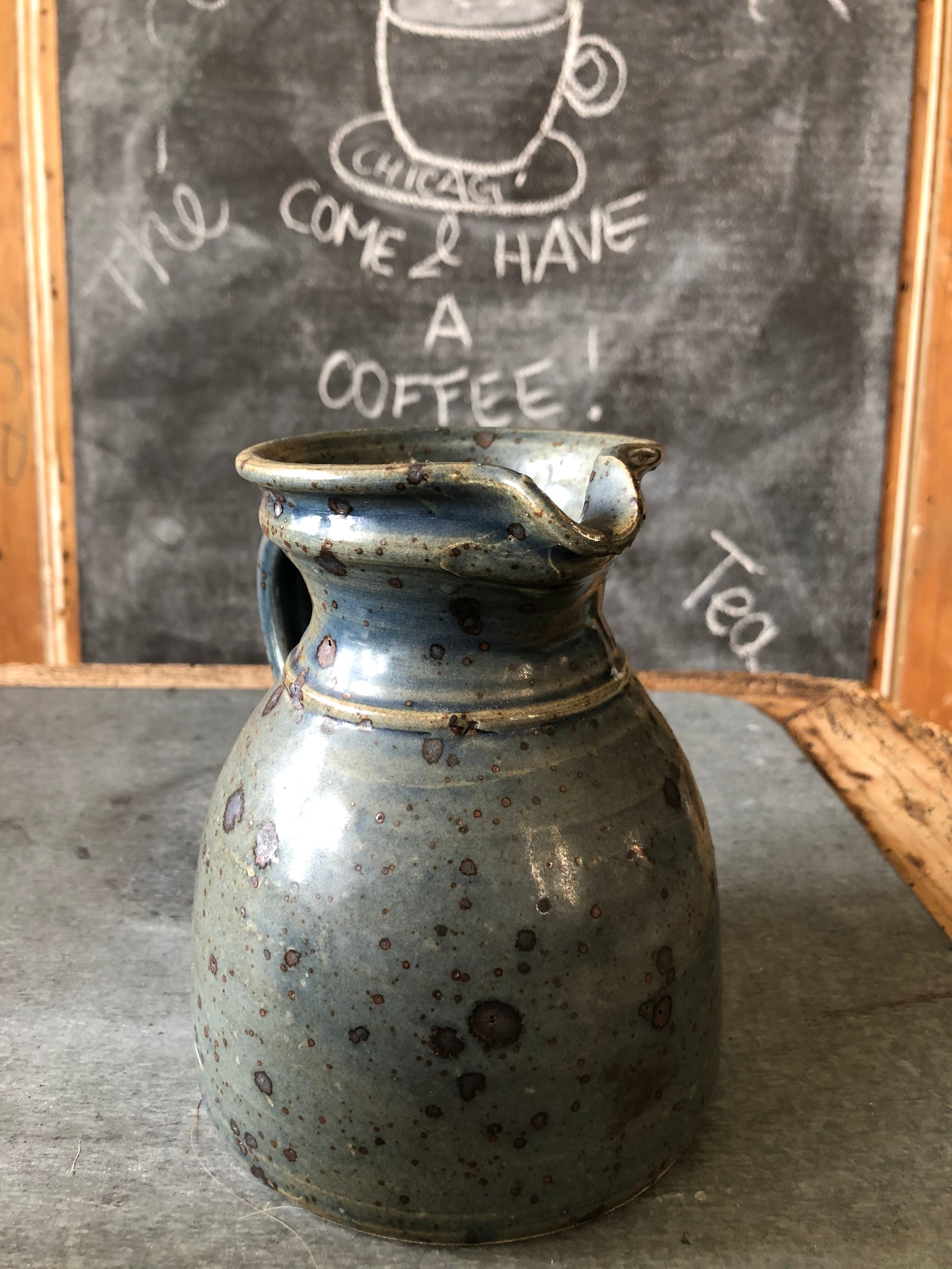 Handmade bluish enamelled sandstone pitcher speckled with brown