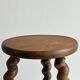 Small antique tripod stool in dark wood.