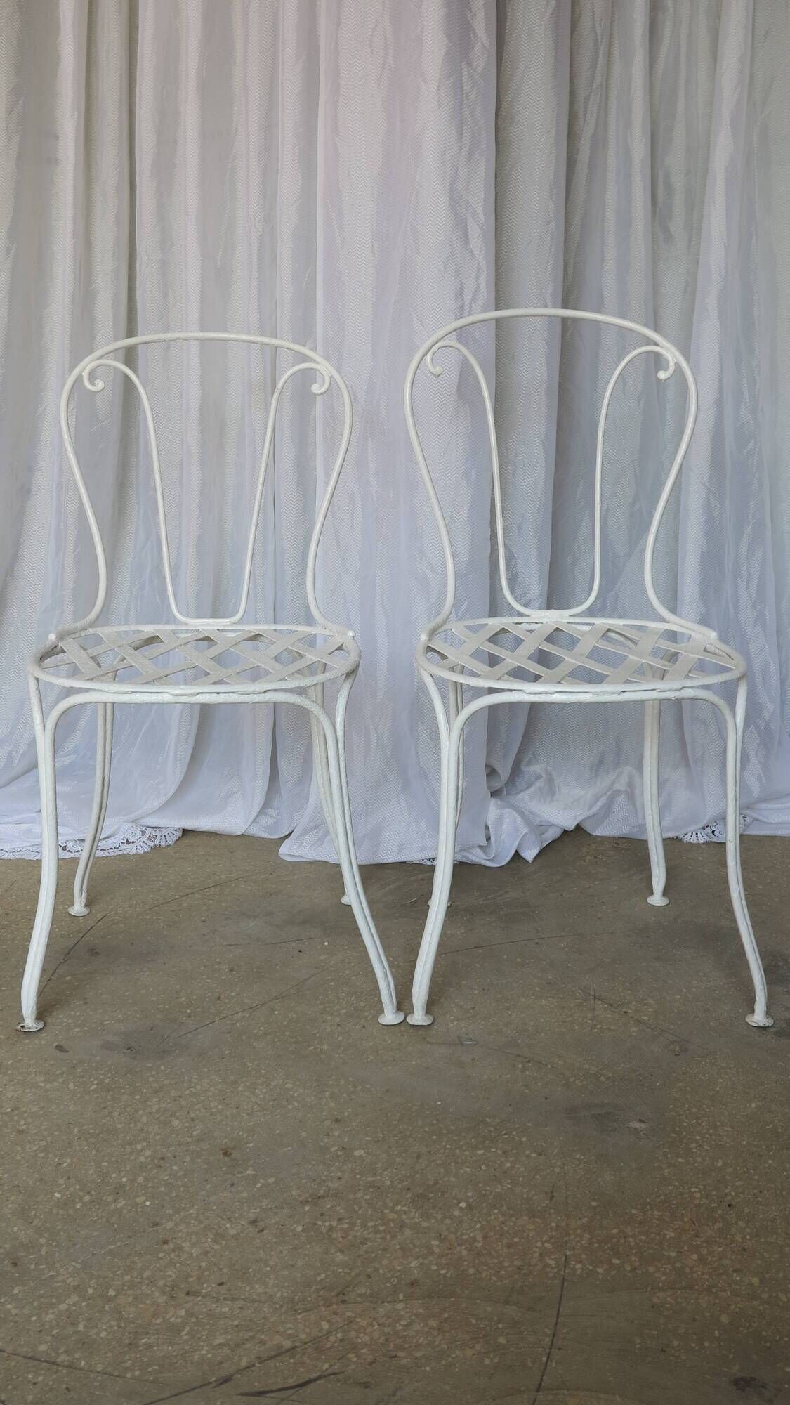 Pair of antique garden chairs, wrought iron, white paint.