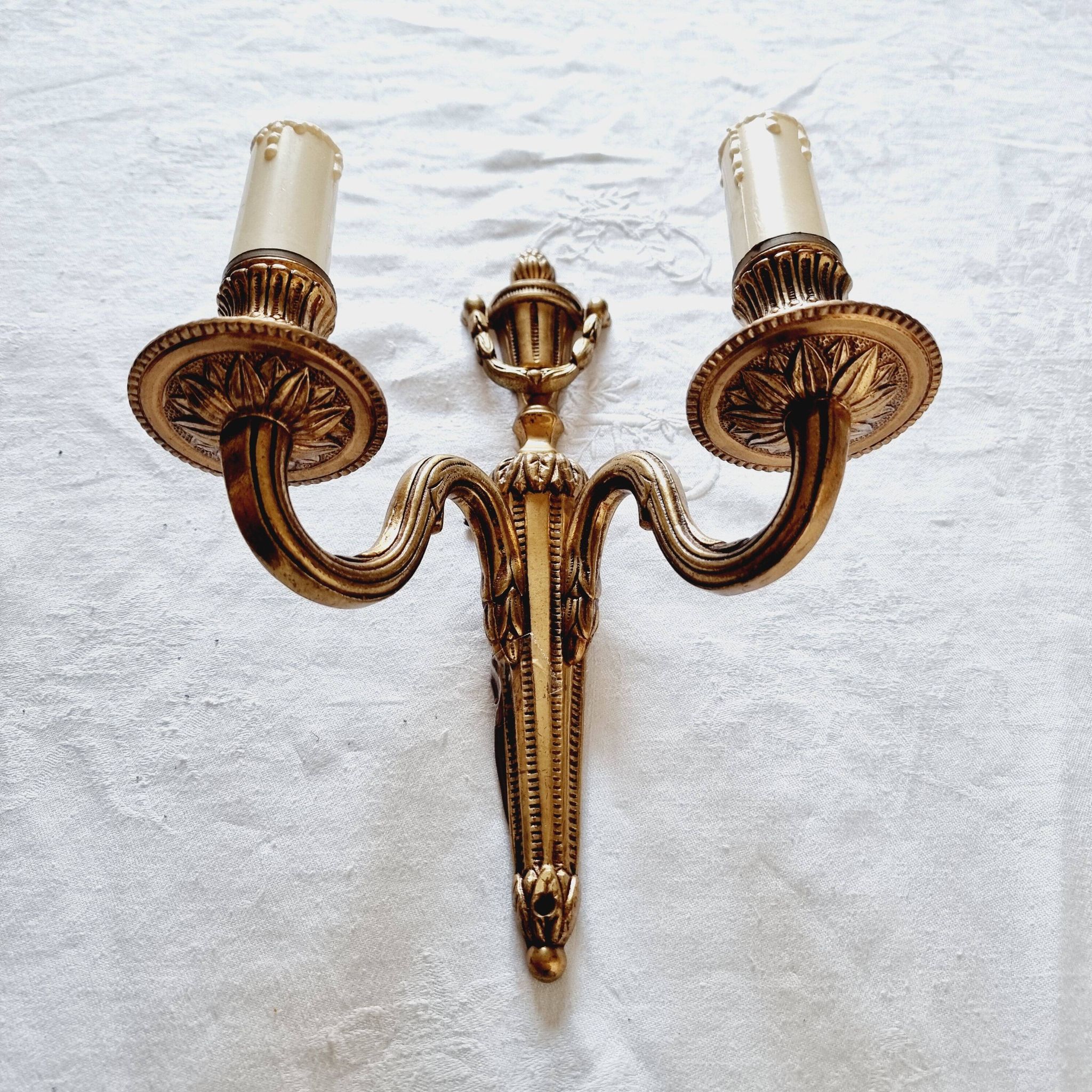 French Empire-style wall sconce or chandelier in bronze with an antique gold patina.