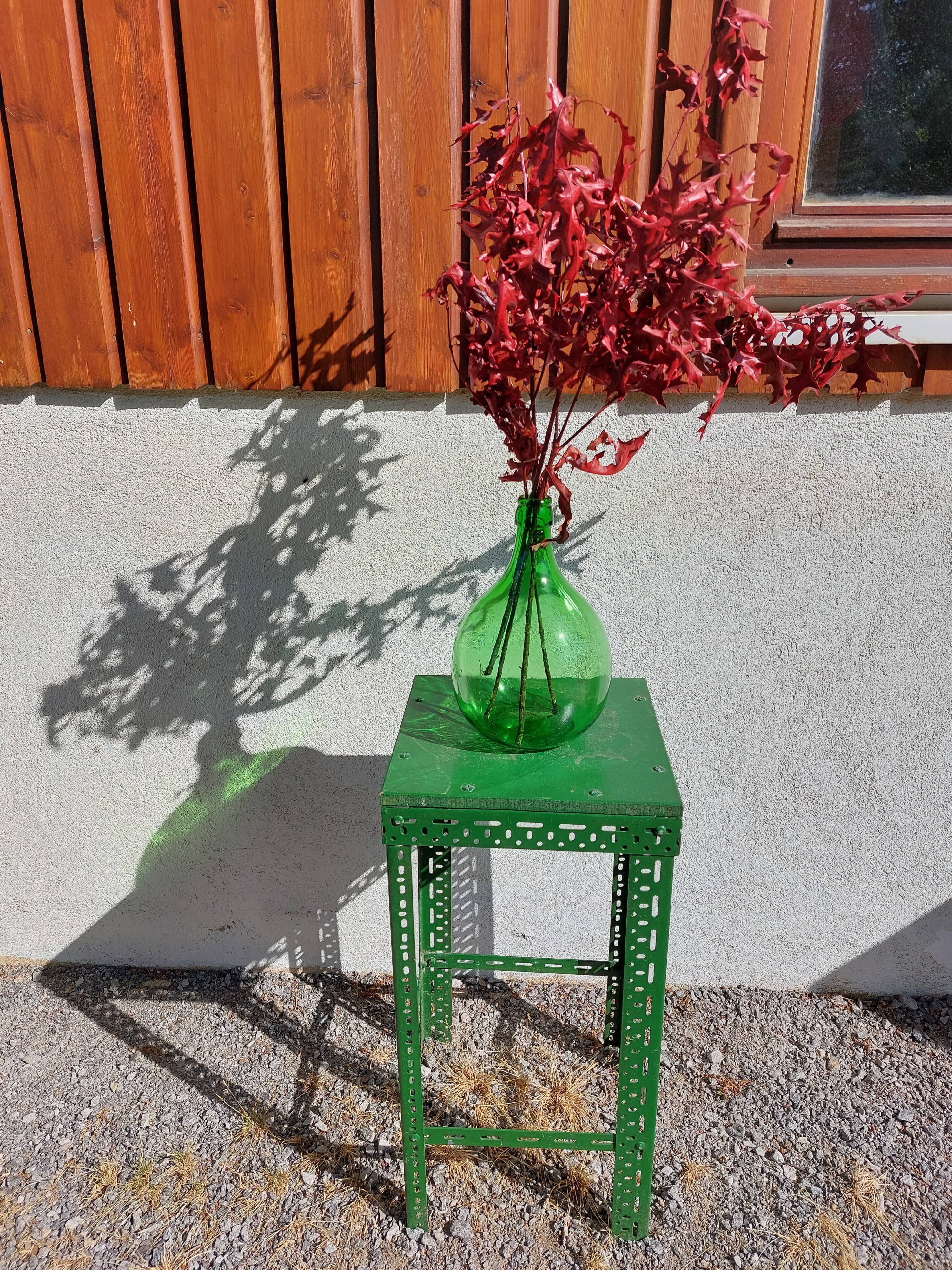 Green metal stool, pedestal table