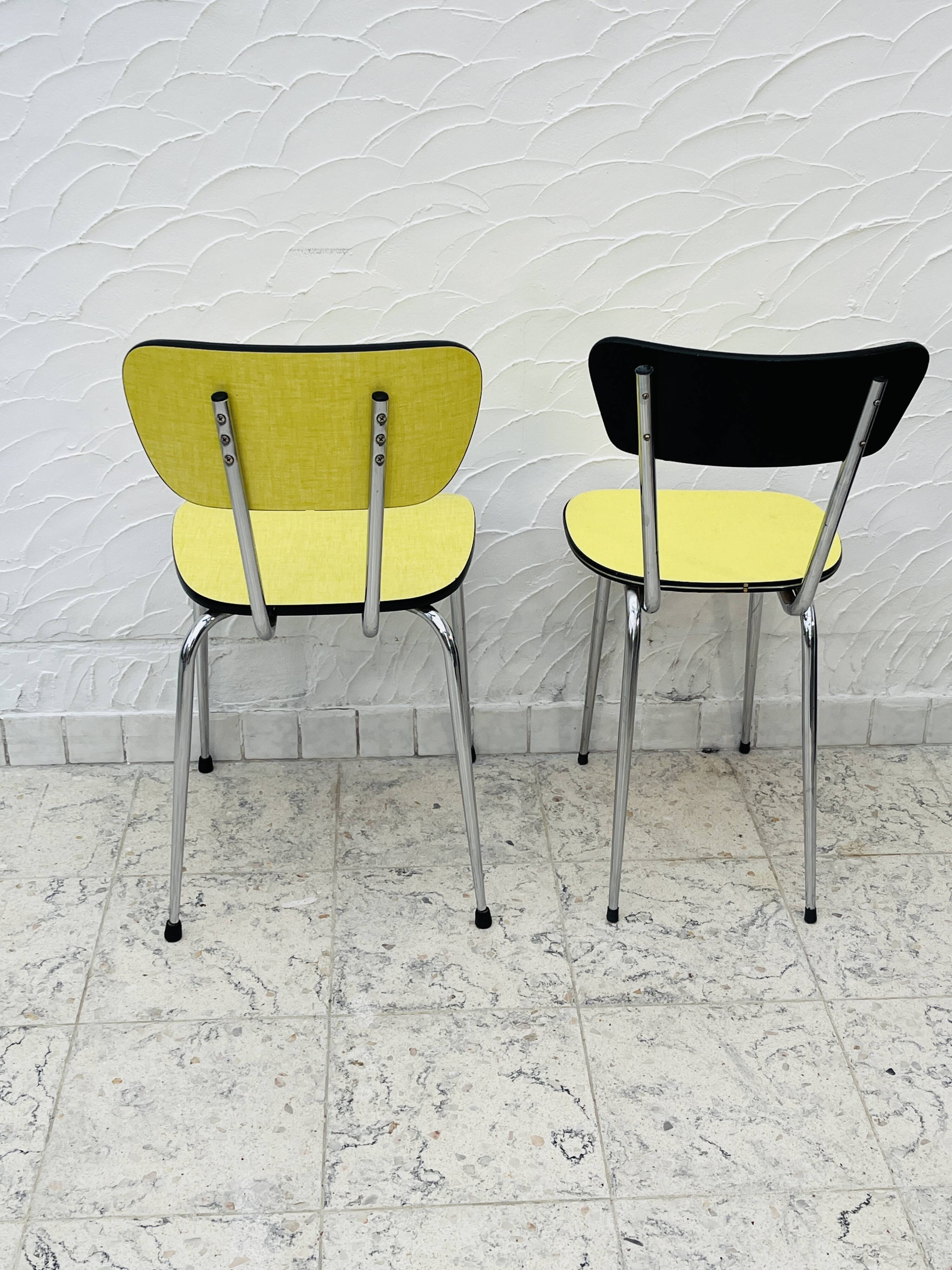 Pair of vintage yellow chrome Formica kitchen chairs.