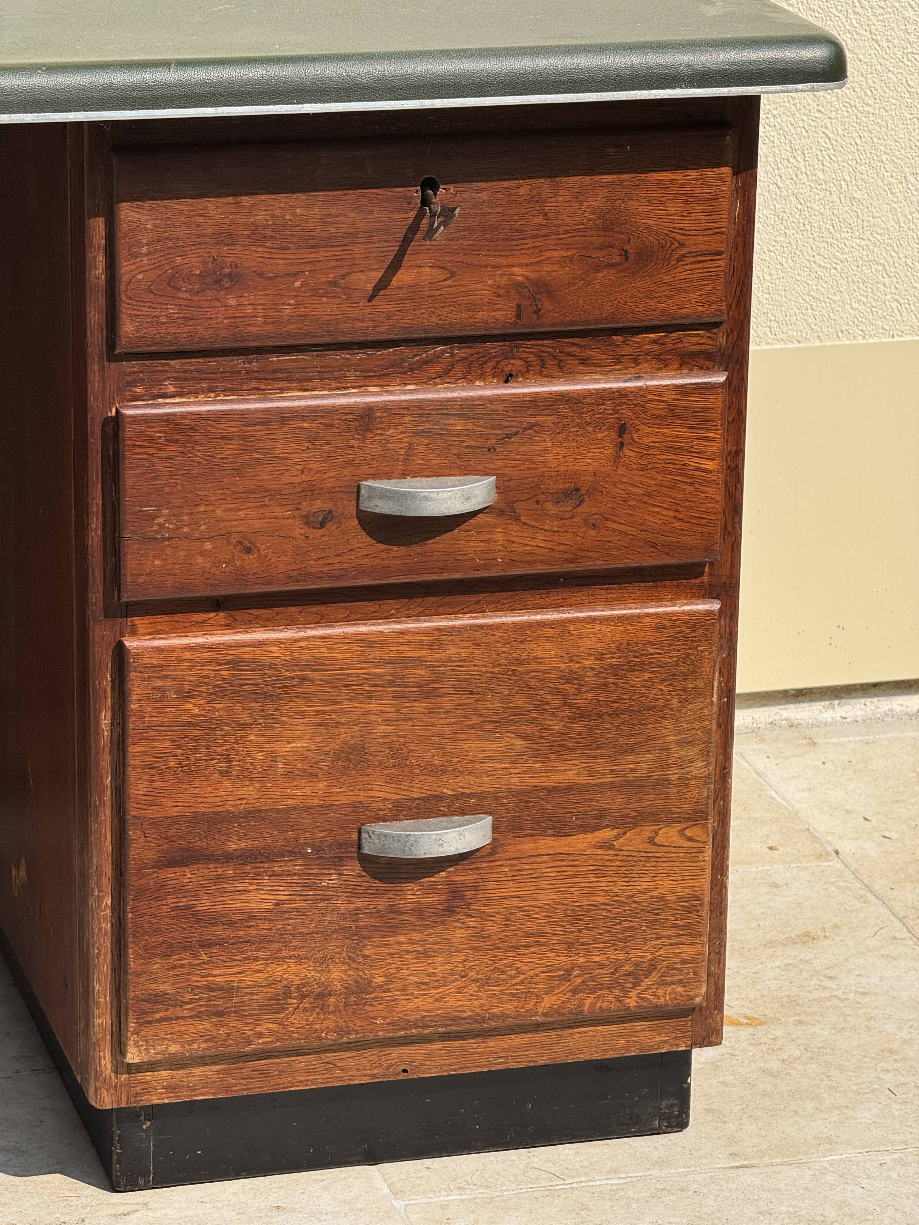 Modernist desk in wood and green moleskin upholstery