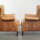 Set of two light cowhide wingback armchairs with a timeless English look