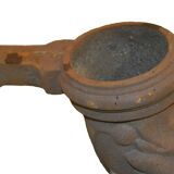 Cast iron gutter downspout in the shape of a dolphin