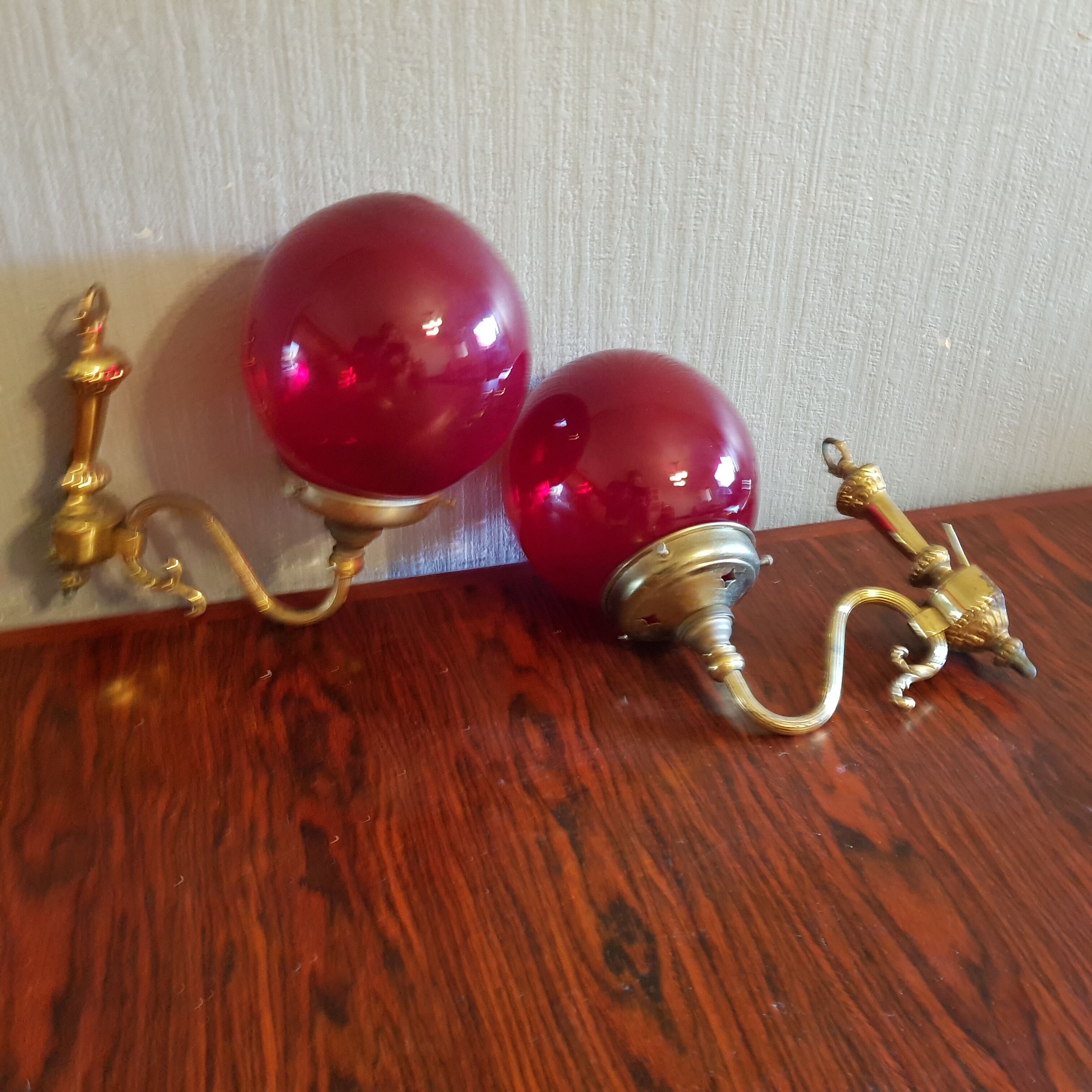 Pair of vintage brass wall light and cherry red globe