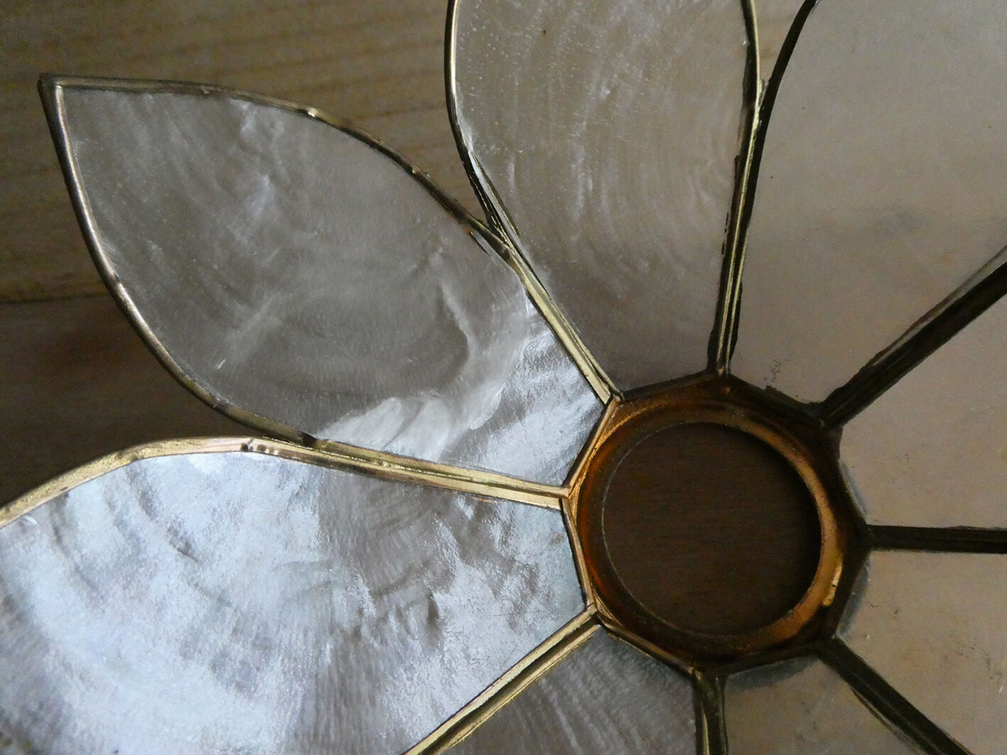 Brass chandelier and flowers in mother-of-pearl petals
