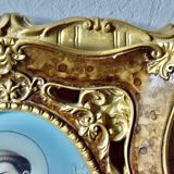 Old religious light frame in gilded stucco and curved glass