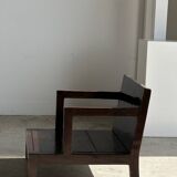 Small low armchair in varnished brown wood