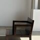 Small low armchair in varnished brown wood