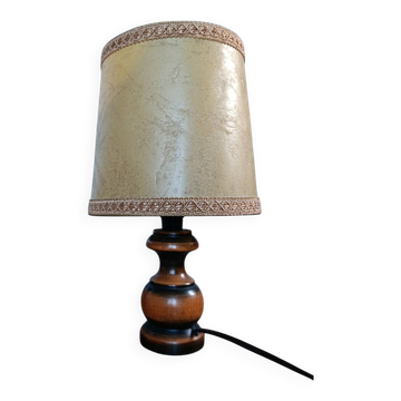 Bedside lamp with turned wooden base, chic rustic leather shade.