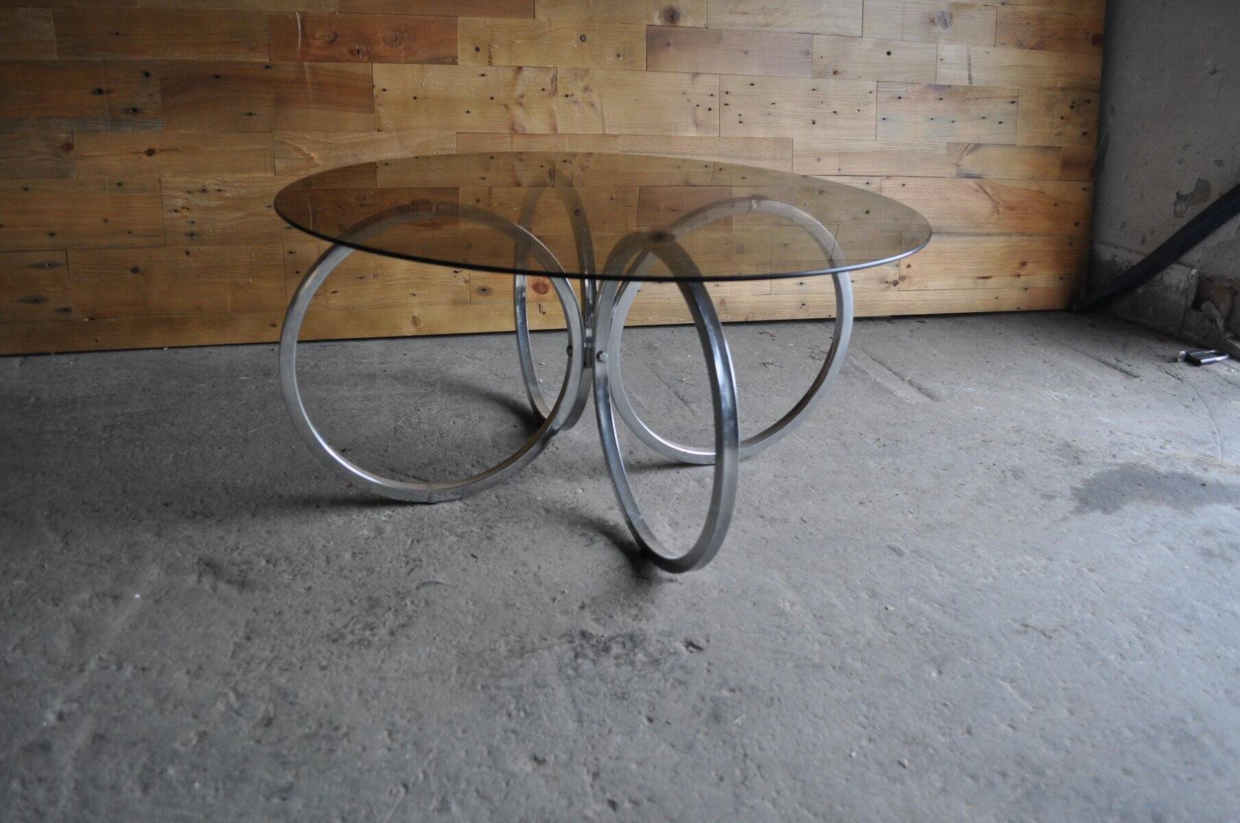 Vintage tubular coffee table in chrome with a transparent glass top, Mid-Century style 1960s.