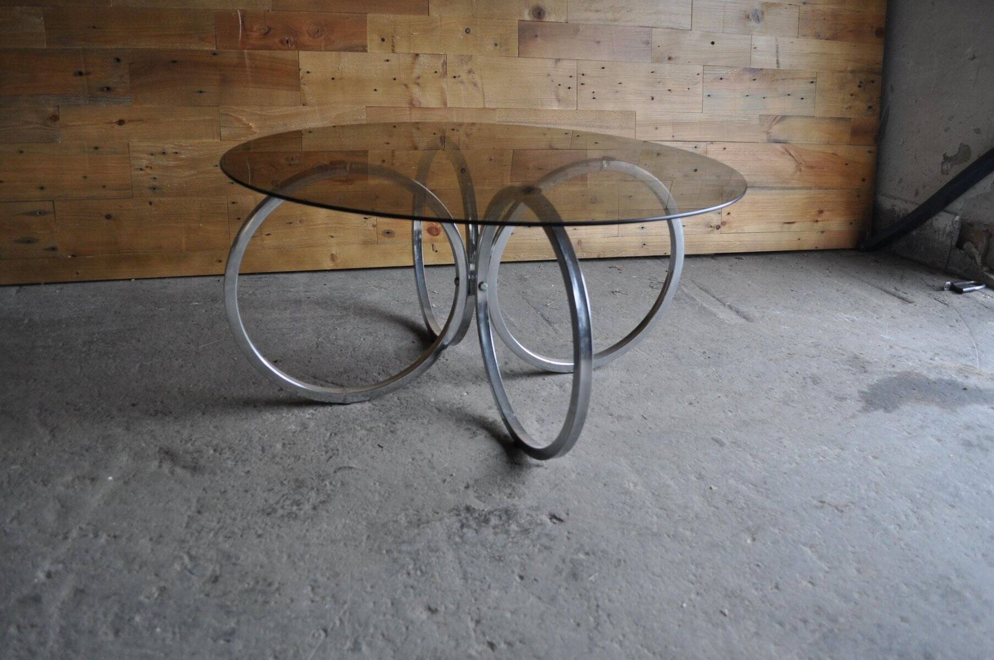 Vintage tubular coffee table in chrome with a transparent glass top, Mid-Century style 1960s.