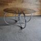 Vintage tubular coffee table in chrome with a transparent glass top, Mid-Century style 1960s.