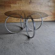 Vintage tubular coffee table in chrome with a transparent glass top, Mid-Century style 1960s.