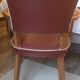 Skai chair binds wine and wooden footpieces and armrests