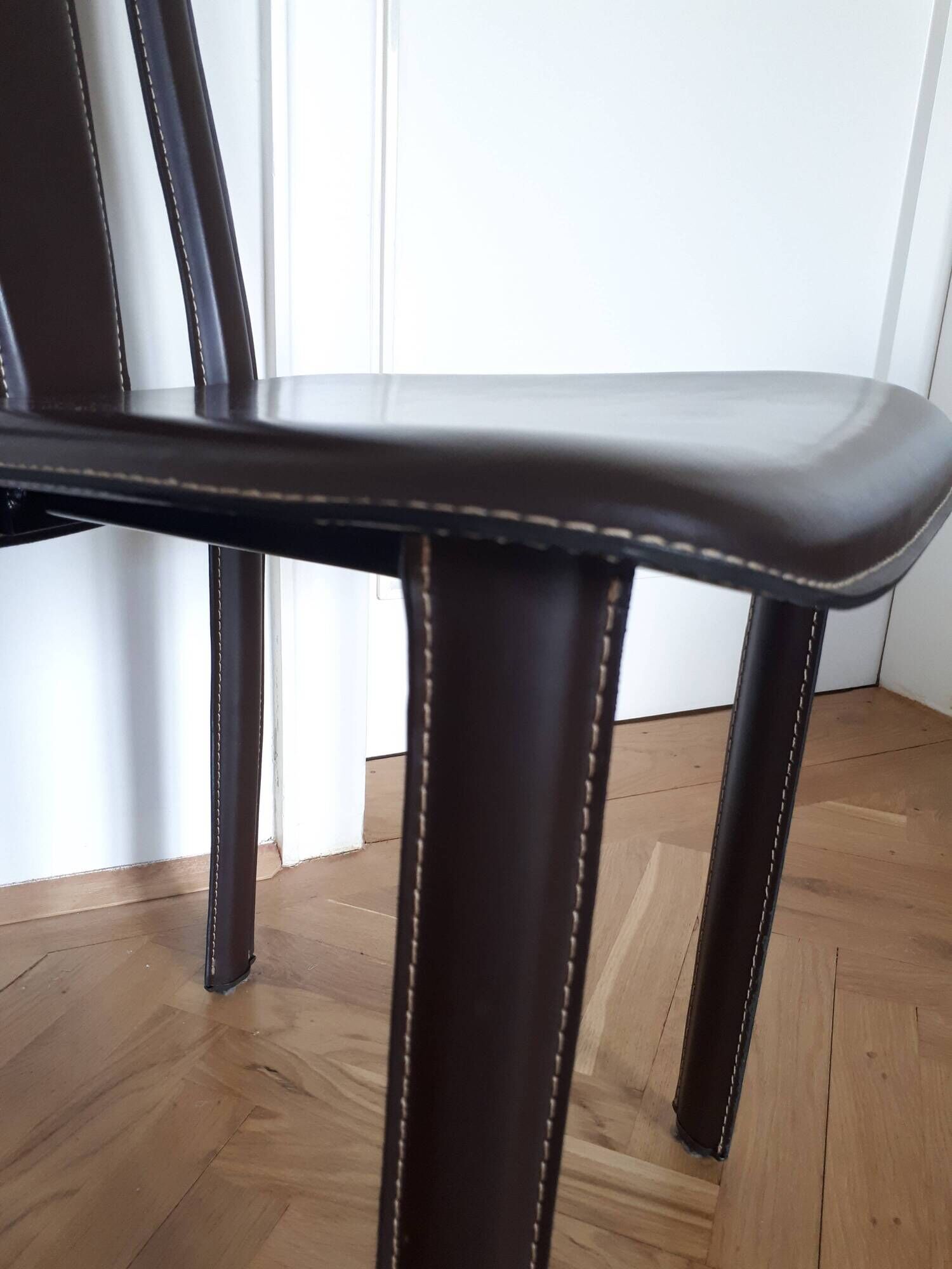 Set of 6 wooden chairs covered in leather.