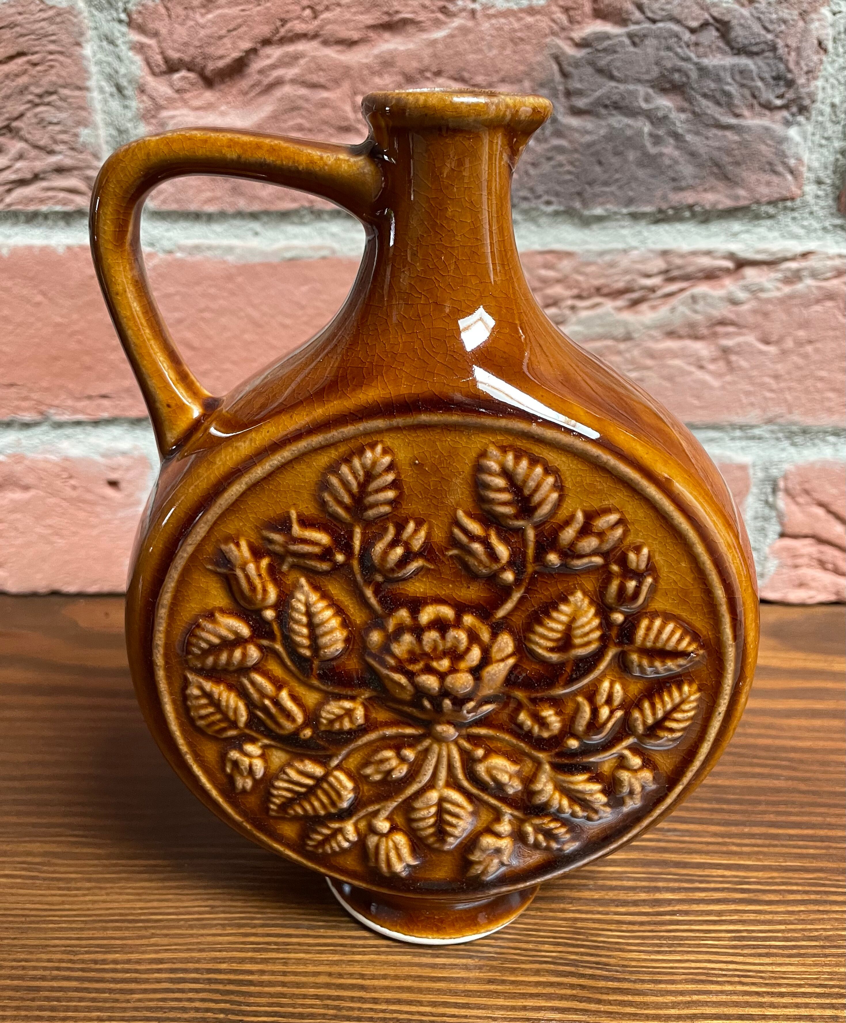 German round vase with floral motif, ornamental brown ceramic jug with handle