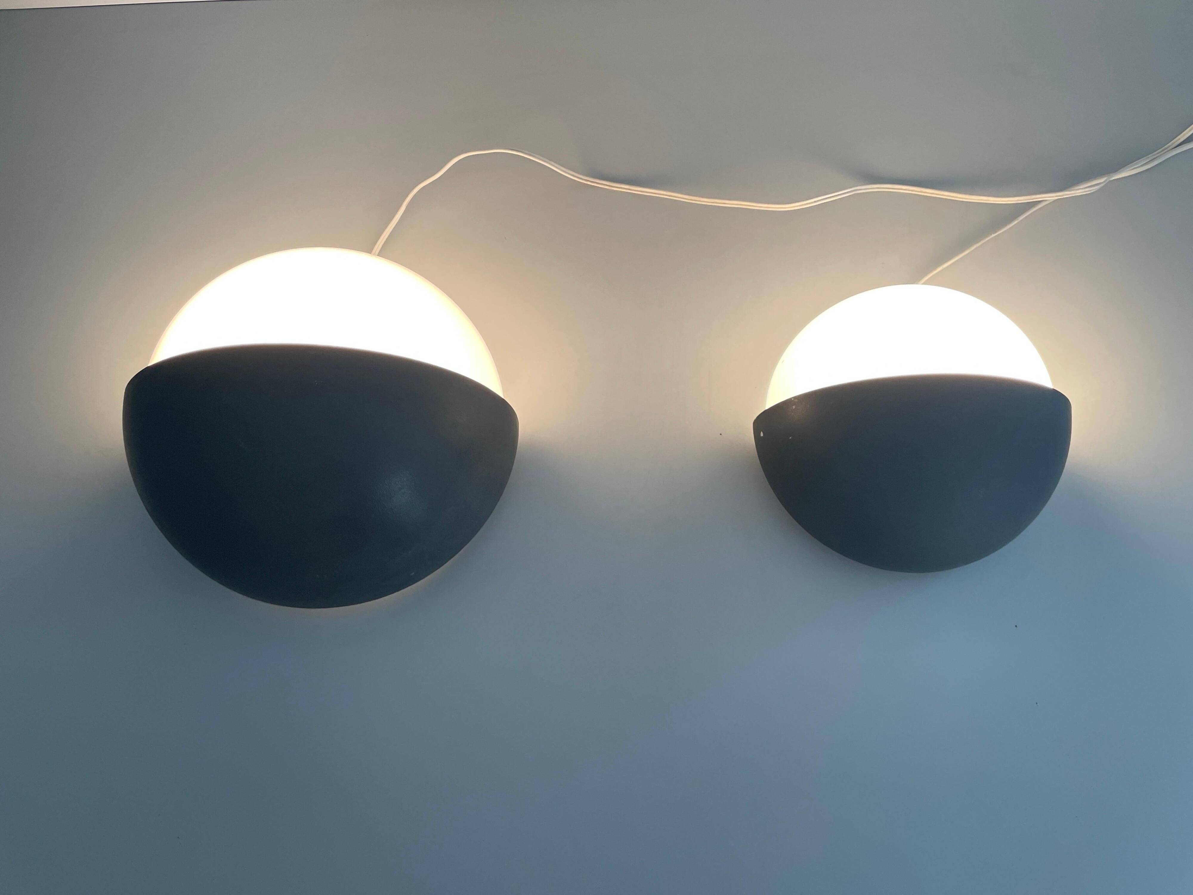 Round black metal wall lights, small and large set, by Bega, 1970s, Germany.