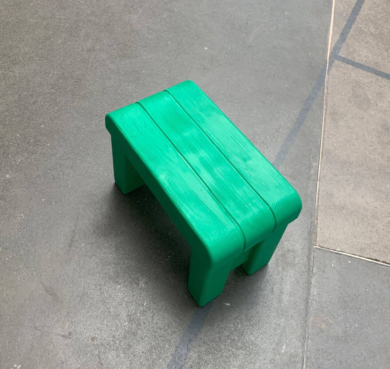Postmodern plastic stool with a wood effect.