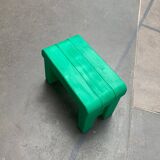 Postmodern plastic stool with a wood effect.