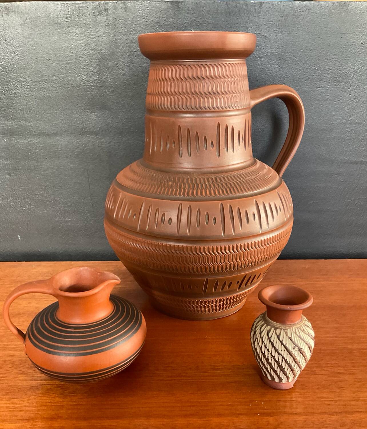 Trio of vintage vases in chiselled terracotta