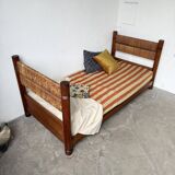 Brutalist style bed with chain and straw