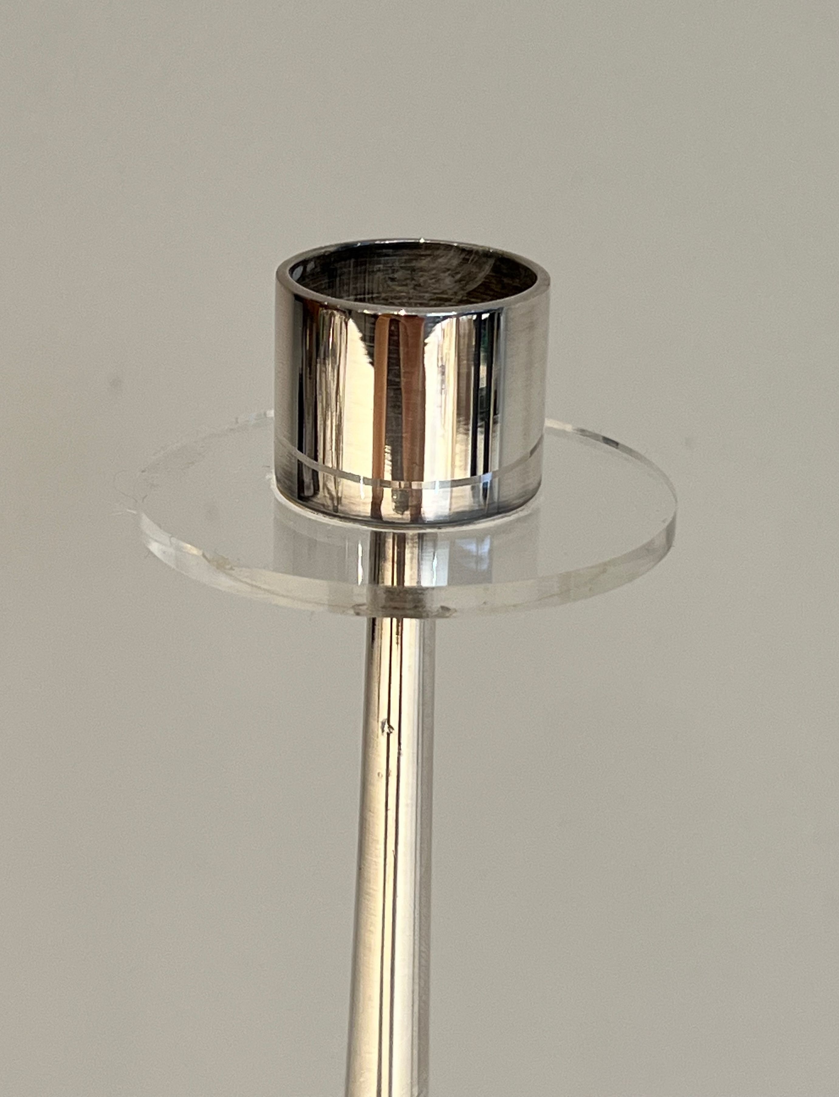 Silver-plated metal and plexiglass design candlestick.