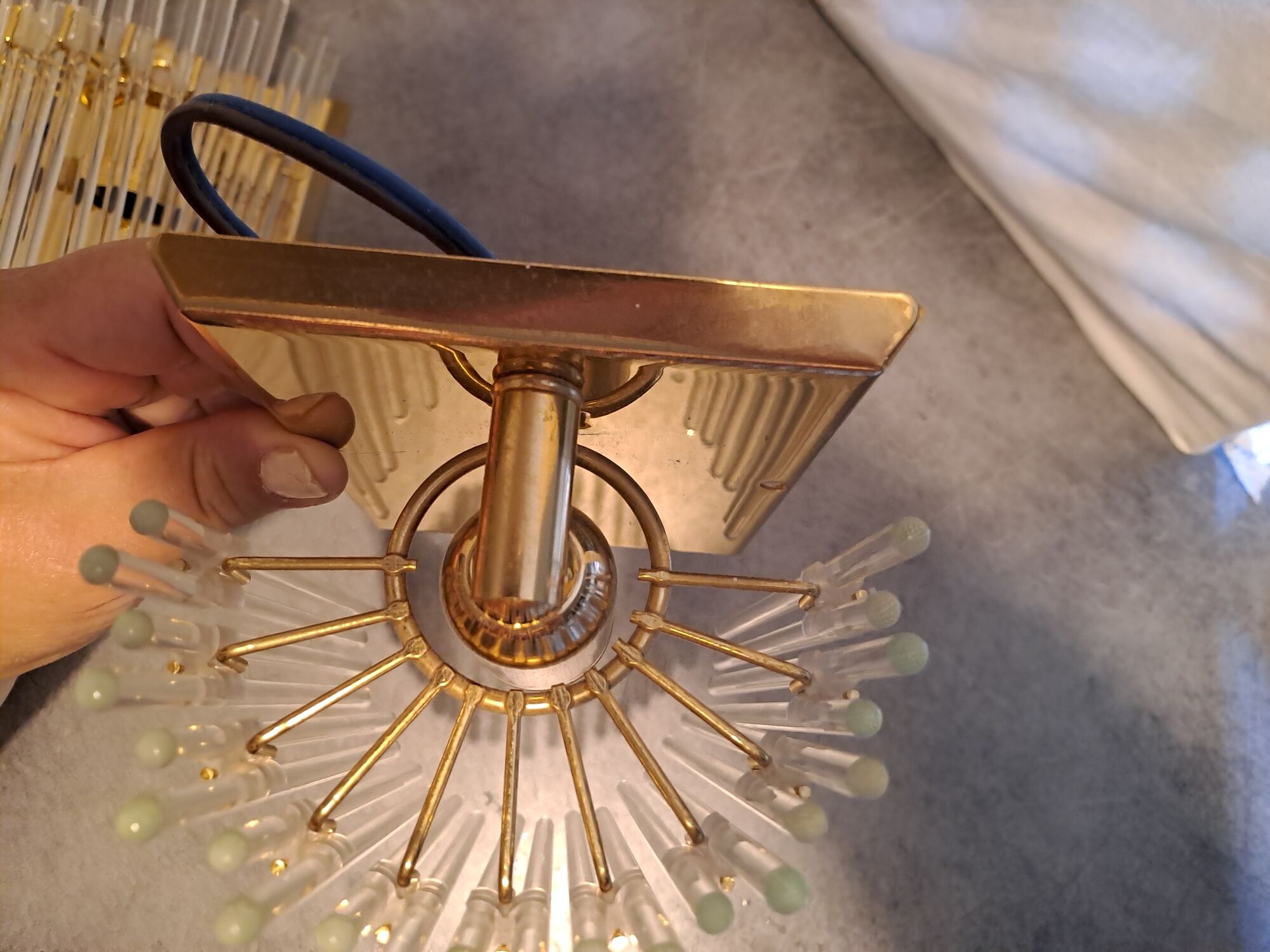 Pair of wall lights with hanging glass pendants in gold color