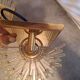 Pair of wall lights with hanging glass pendants in gold color