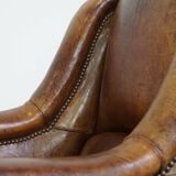 Characteristic antique sheepskin leather armchair with beautiful details and a unique design