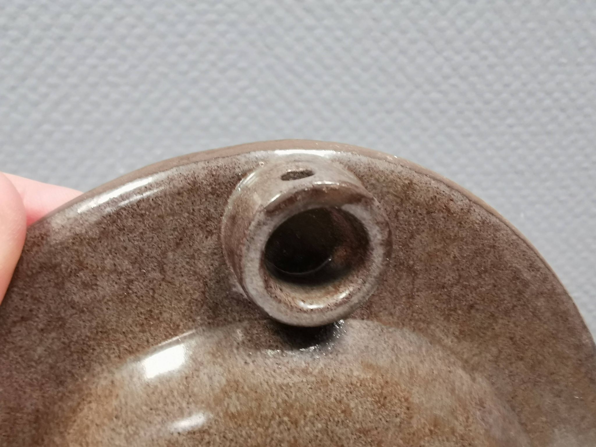 Wall-mounted candlestick in grayish colors, Danish and from the 1970s-80s.