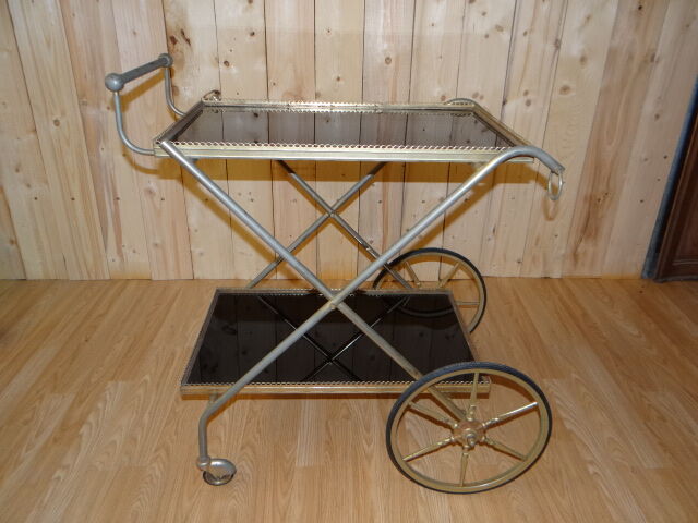 Rolling dessert in gold metal and trays in black formica