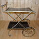 Rolling dessert in gold metal and trays in black formica